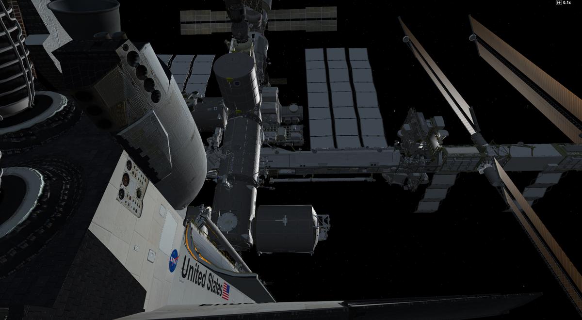 View of the ISS from the tail section of the Shuttle